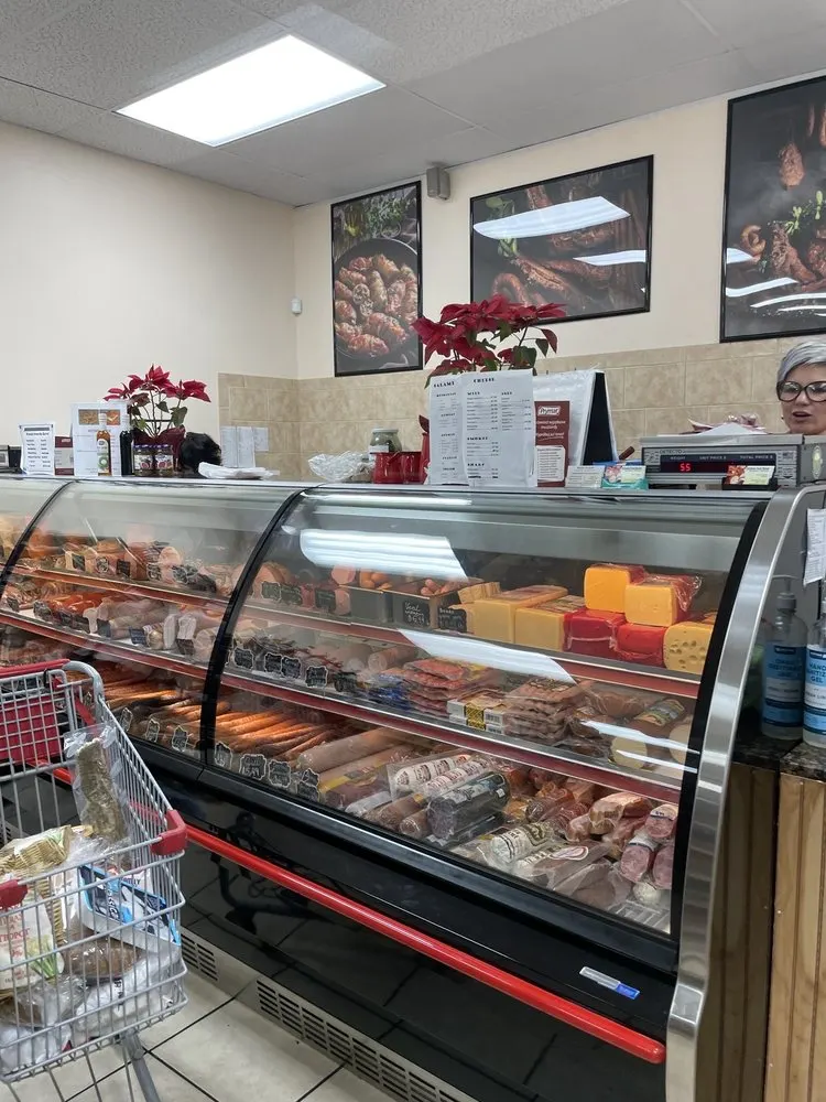 Inside the market, the deli counter and cheese case